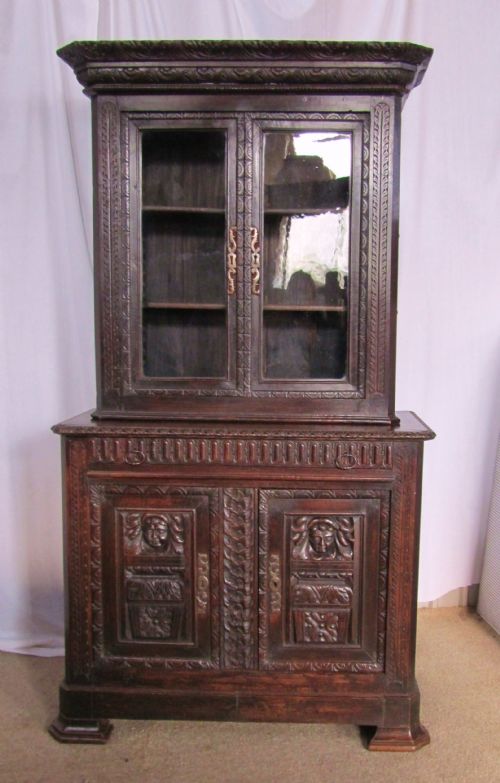 french gothic green man carved oak game cupboard bookcase
