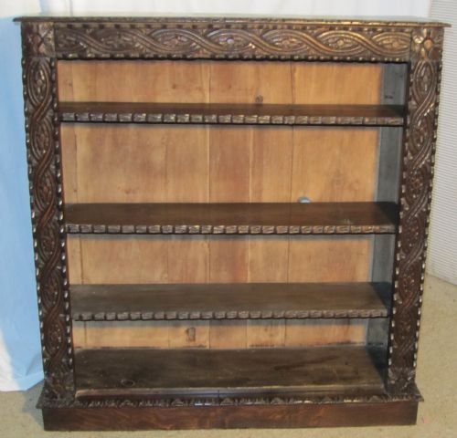 a victorian carved gothic oak floor standing shelf or book case