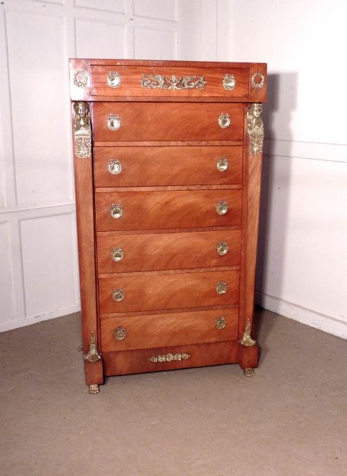 a tall french art deco walnut chest of drawers in the neo classical style