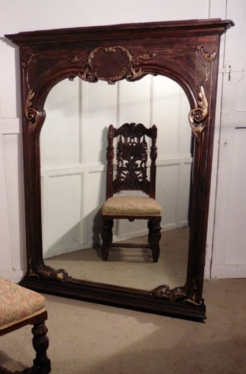 a very large french carved oak wall mirror