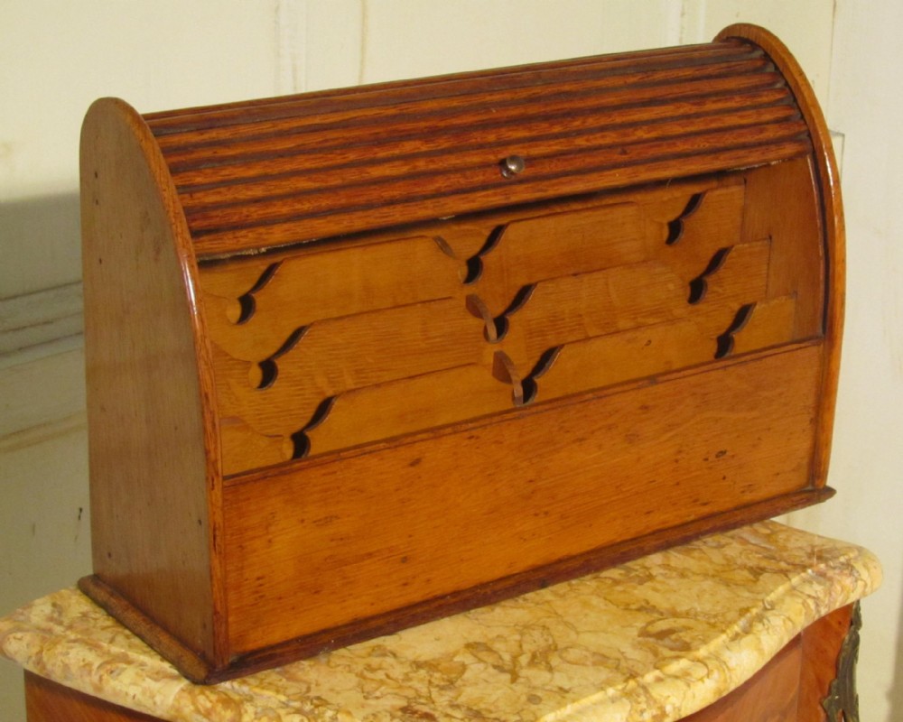 a charming arts and crafts golden oak stationary box with a tambour top