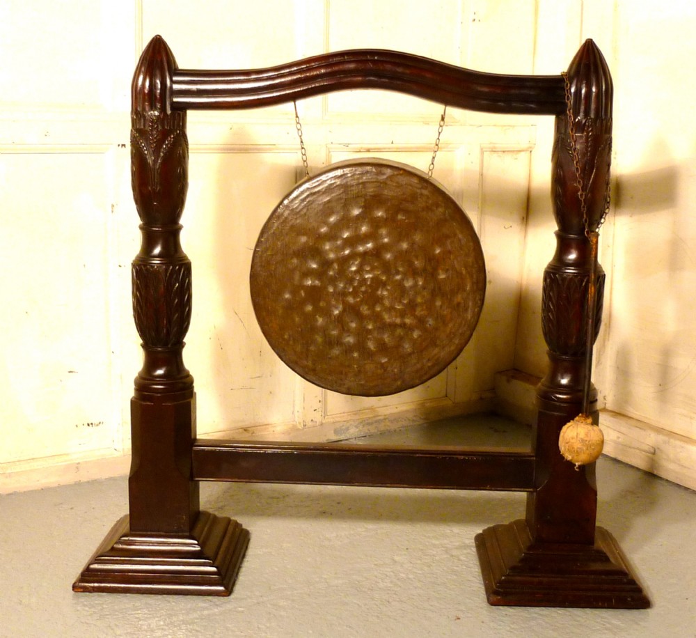 a large carved mahogany brass dinner gong
