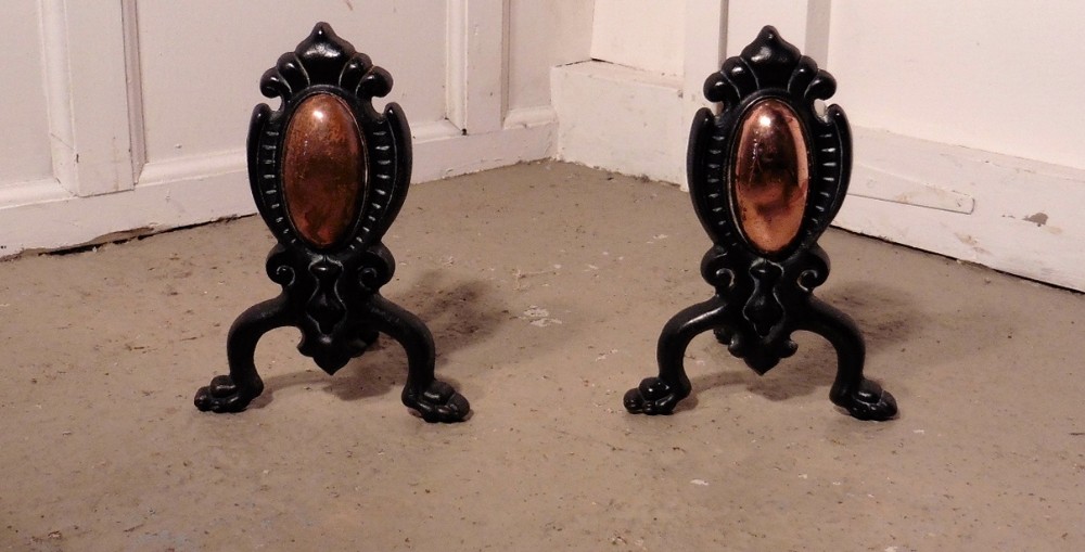 a pair of art nouveau copper and iron andirons or fire dogs