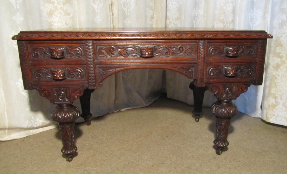 a victorian superbly carved pussy oak or green man desk