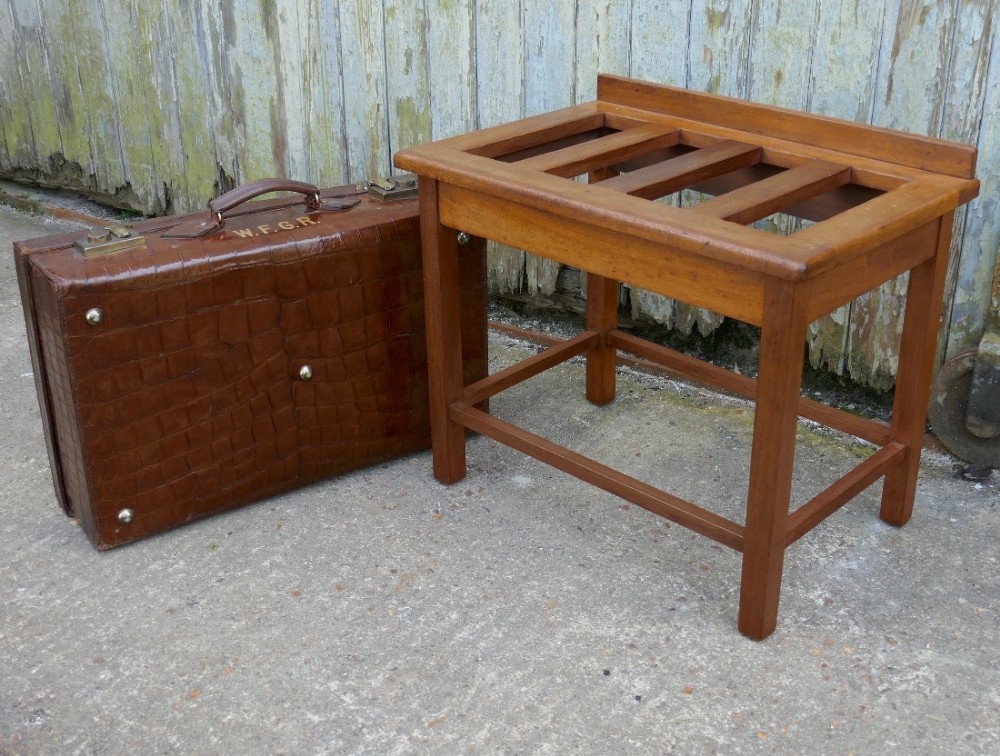 a sturdy golden blond mahogany luggage rack suitcase stand