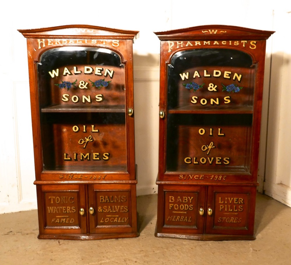 a pair of victorian mahogany sign painted chemists or bathroom cupboards