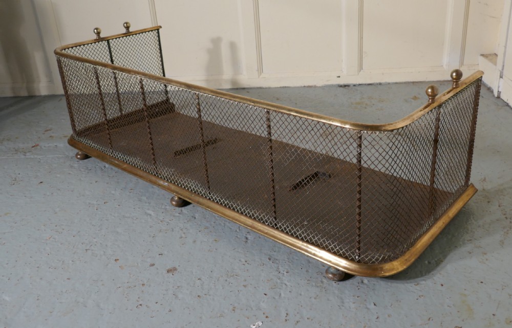 a large victorian brass and iron fender or fireguard