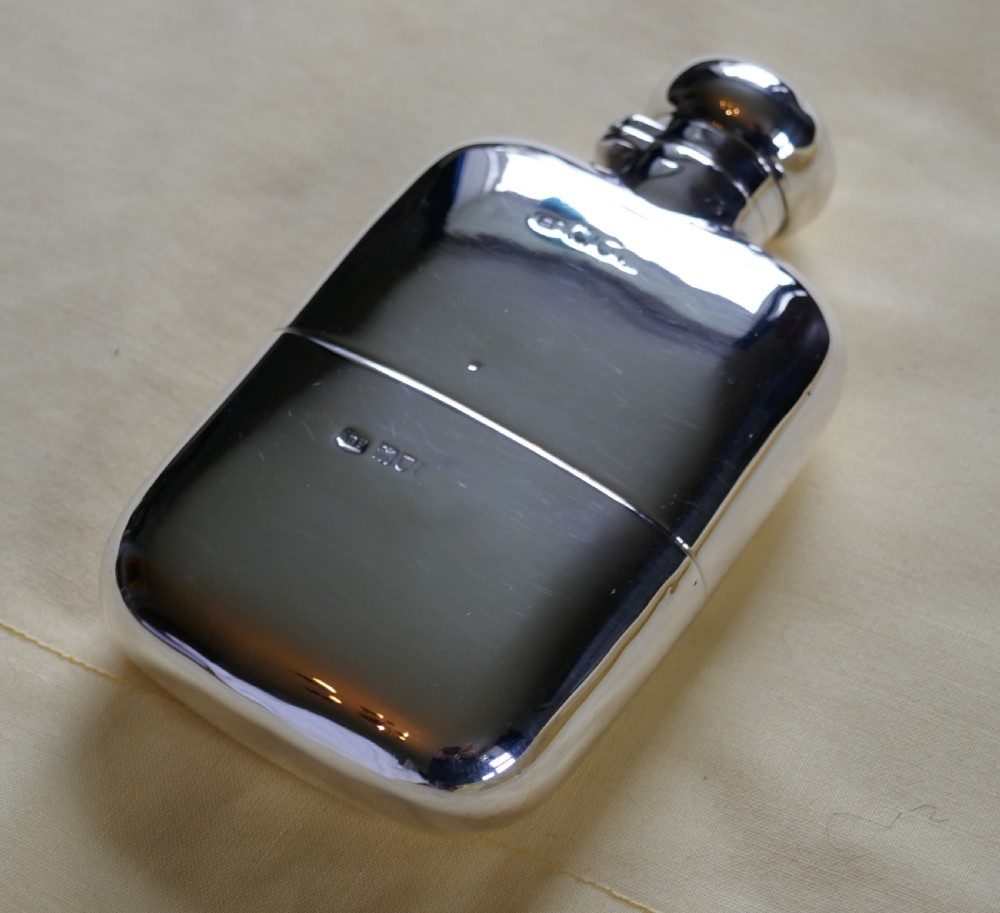 a solid silver hall marked hip flask and cup by finnigans ltd 1900