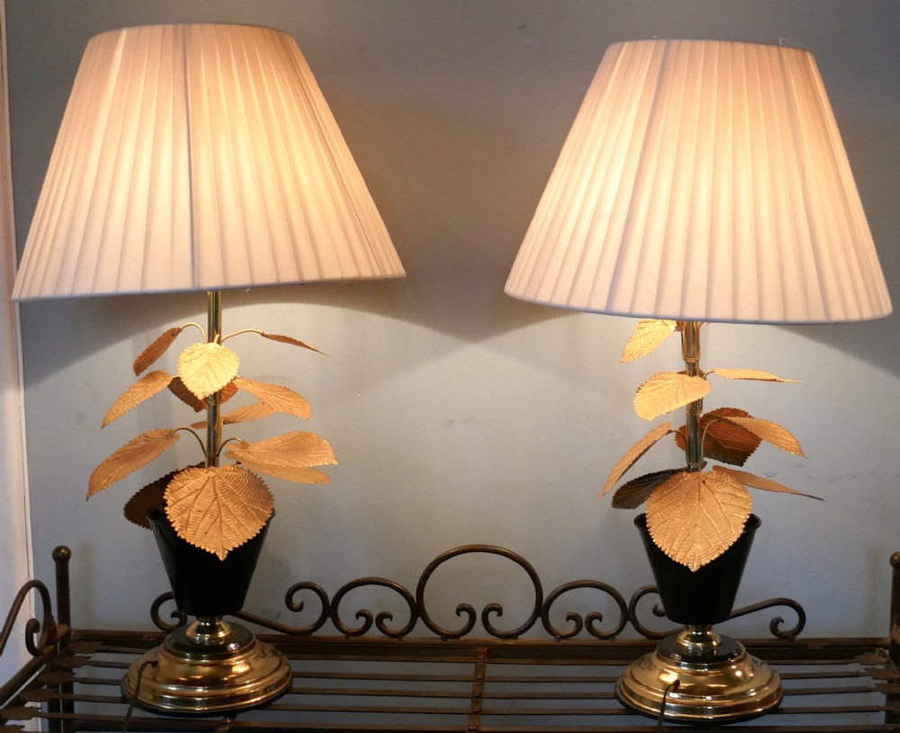 a pair of french art deco table lamps decorated with brass leaves