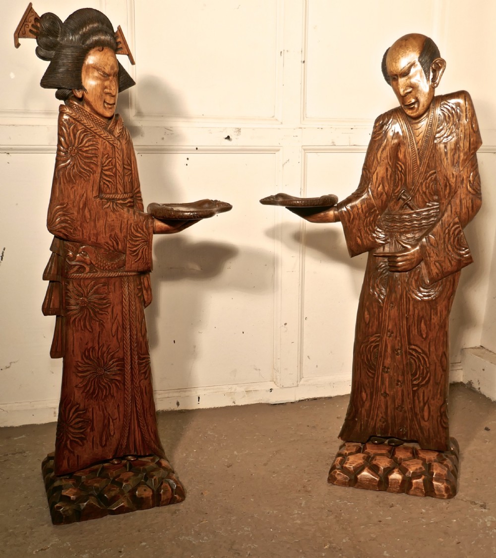 pair of carved japanese carved 3d dumb waiters or card butler greeters