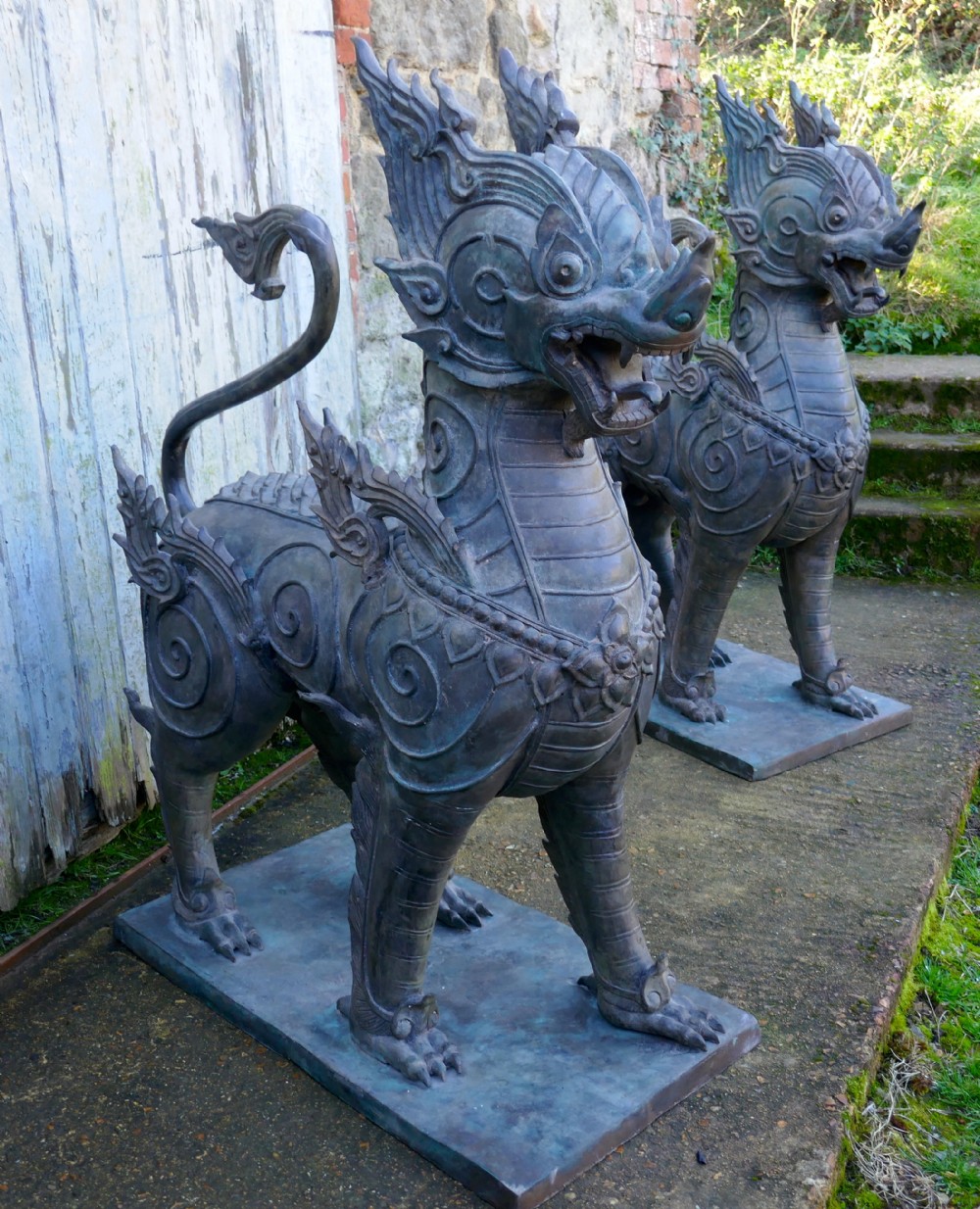 a pair of large bronze thai temple guardian foo lion dogs