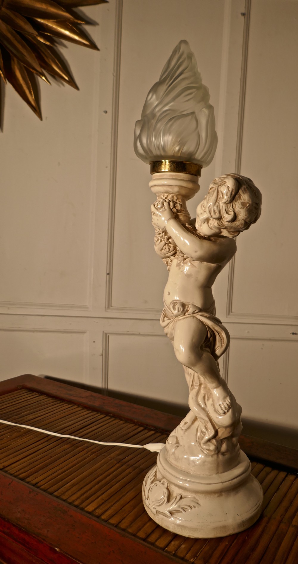 a large ceramic table lamp in the form of a cherub or putti