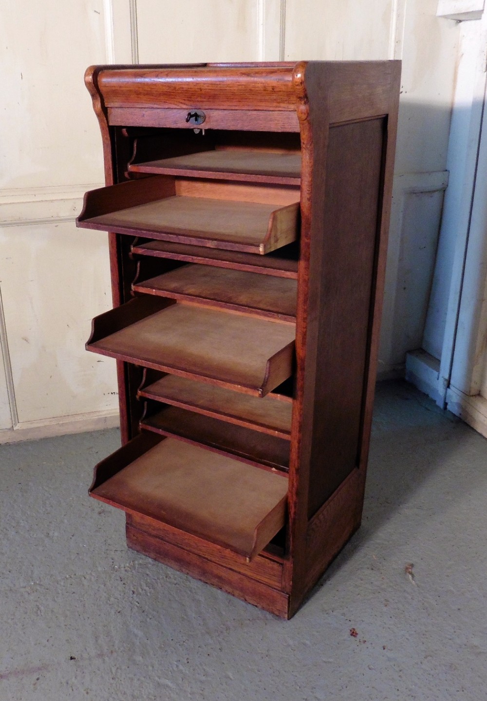 tambour fronted oak art deco filing cabinet with slide shelves