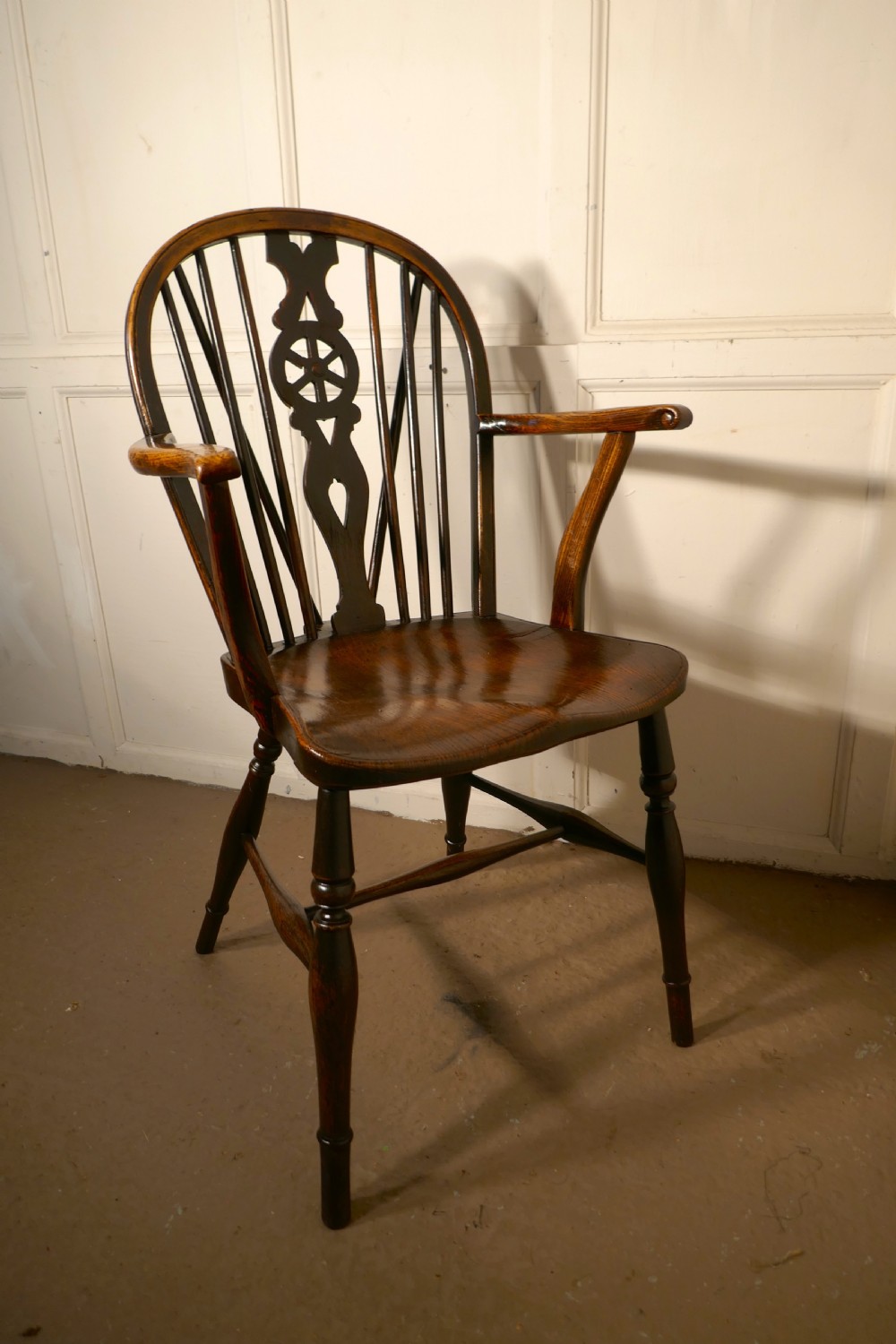 an early victorian beech and elm wheel back carver chair