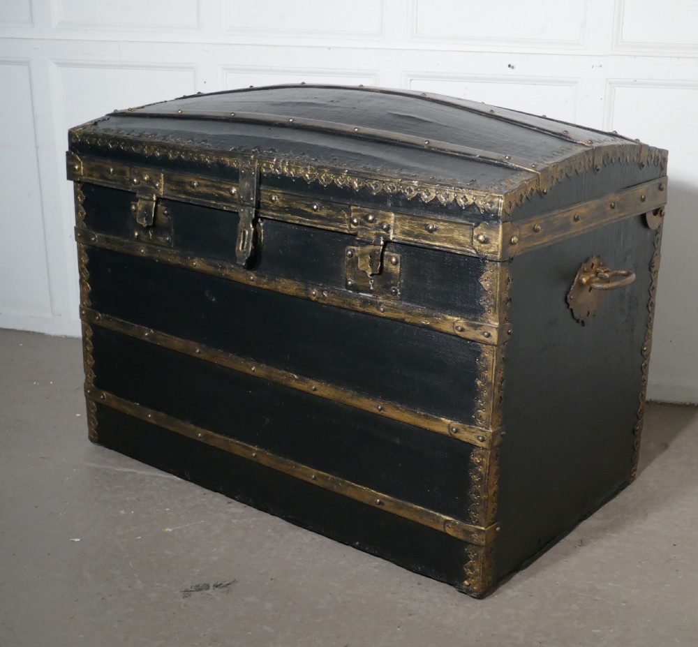 a victorian canvas dome top traveling trunk