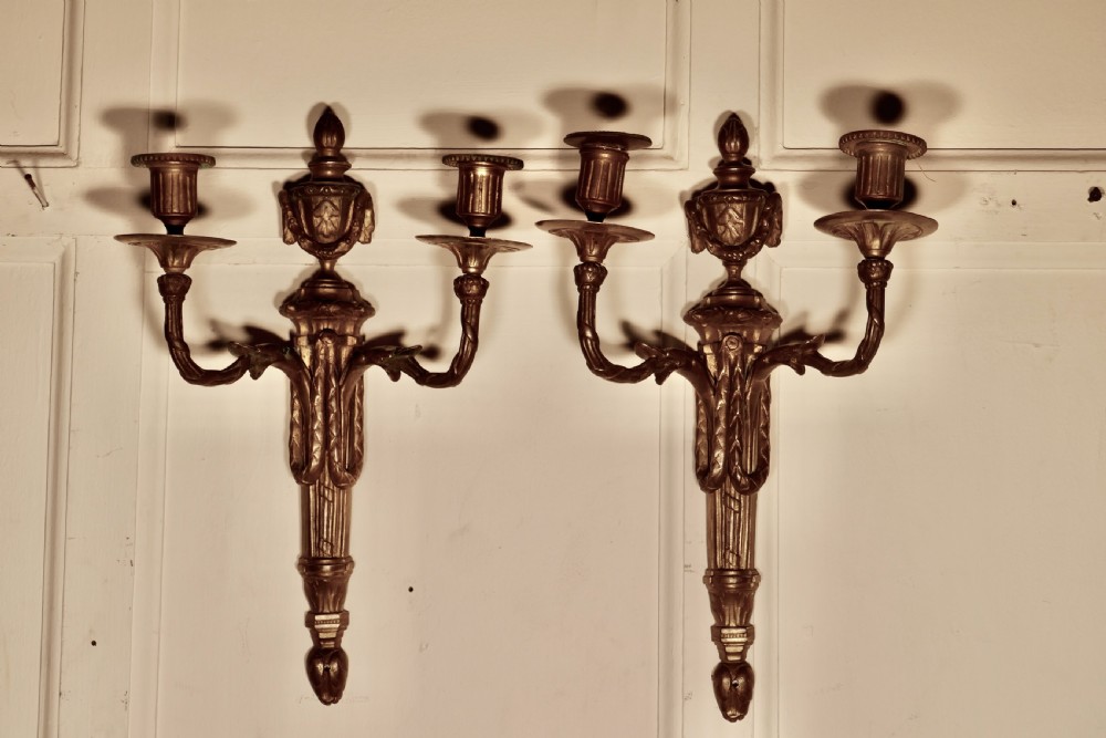 an early 19th century pair of french brass twin wall sconces
