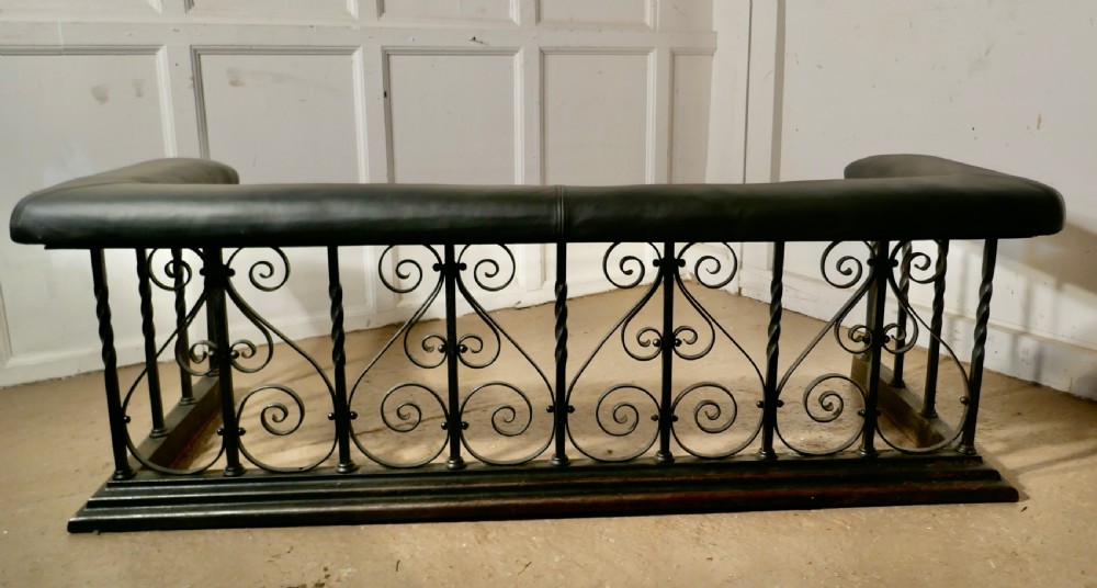 large decorative wrought iron and leather club fender