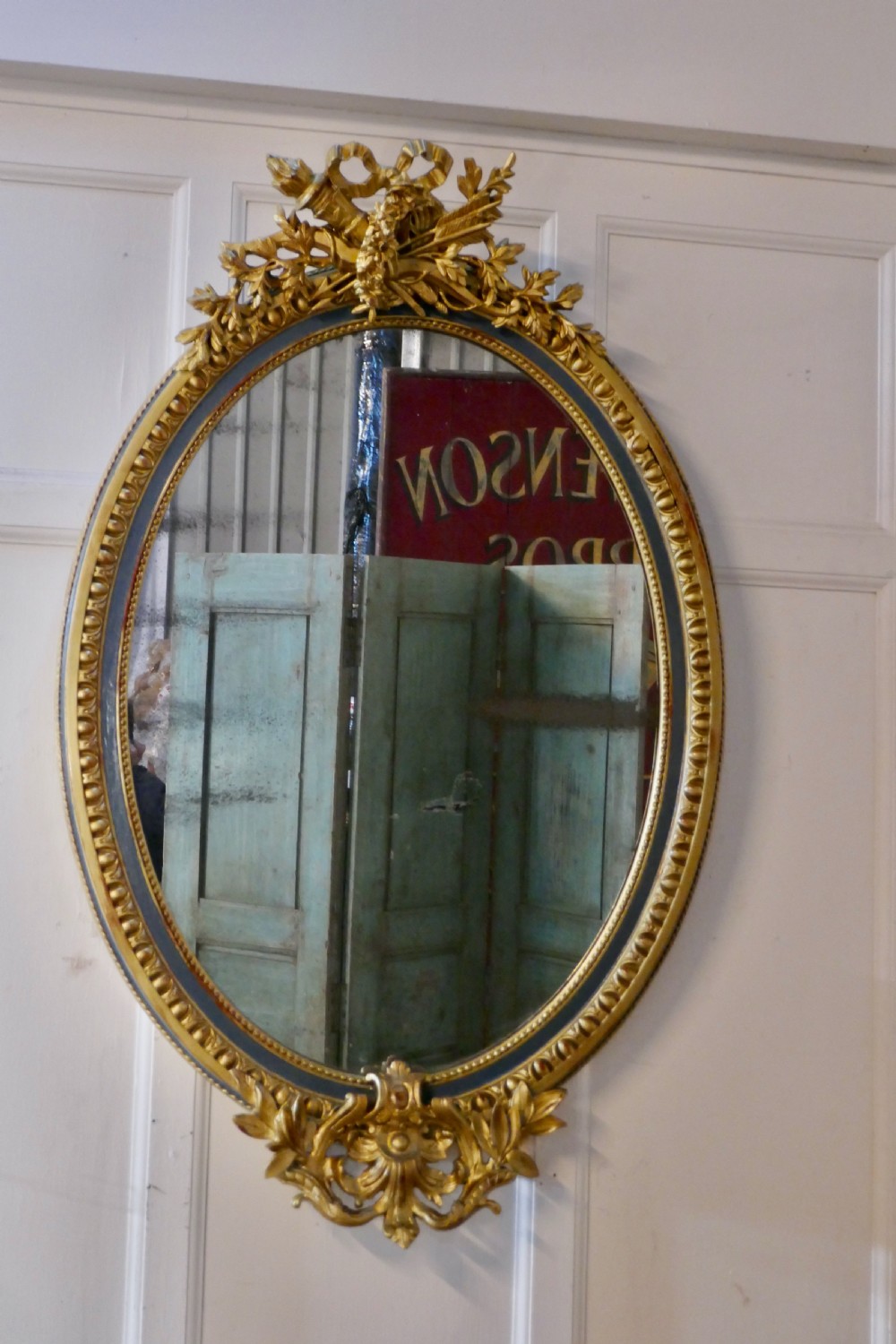 a large french rococo oval gilt wall mirror
