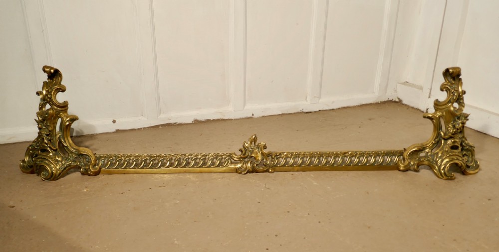 large french rococo brass extending fender with decorative chenets