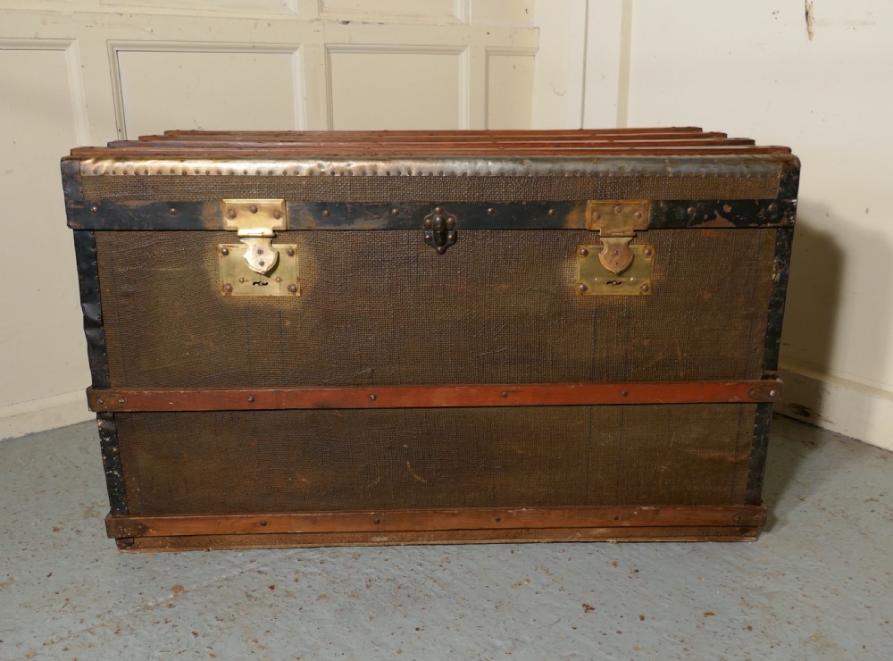 a vintage brass and bound canvas travel steamer trunk