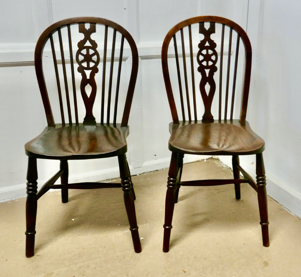 a pair of victorian beech elm wheel back chairs