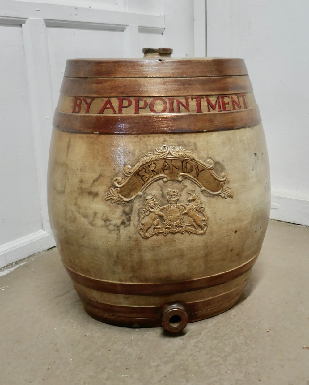a very large 19th century stoneware brandy barrel with royal coats of arms
