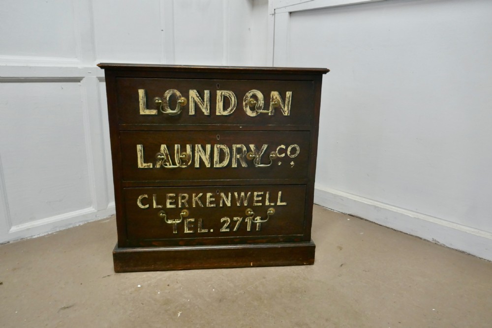 painted chest of drawers advertising the london laundry co