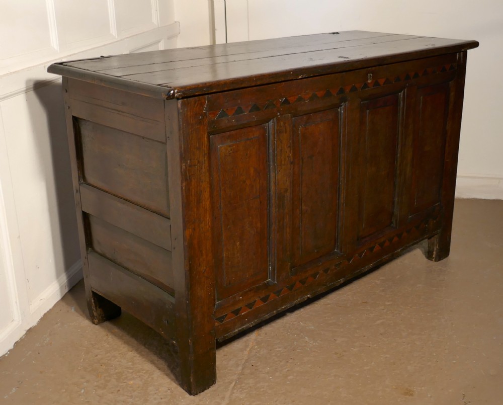 a large 17th century inlaid panelled oak coffer