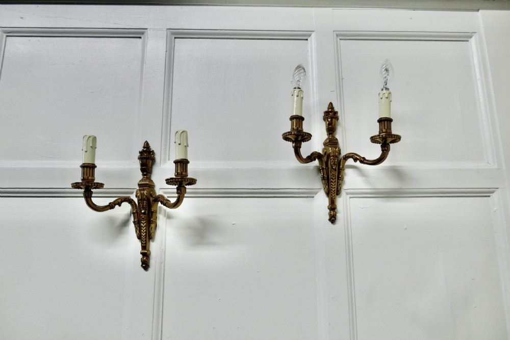 a pair of brass twinwall lights