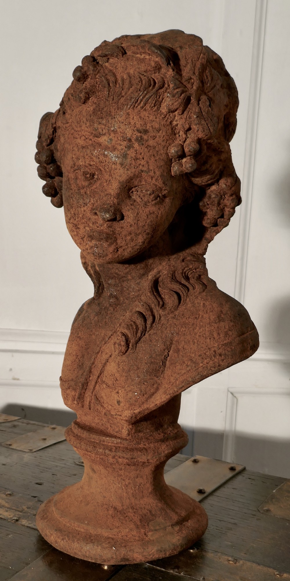 weathered iron bust of a woman