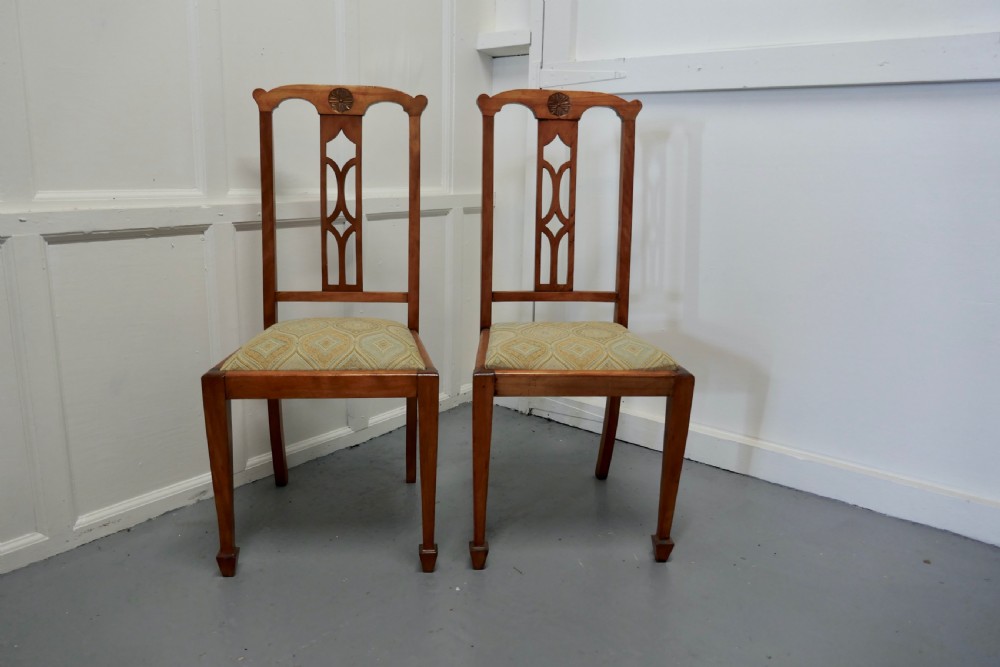 pair of arts crafts golden oak chairs