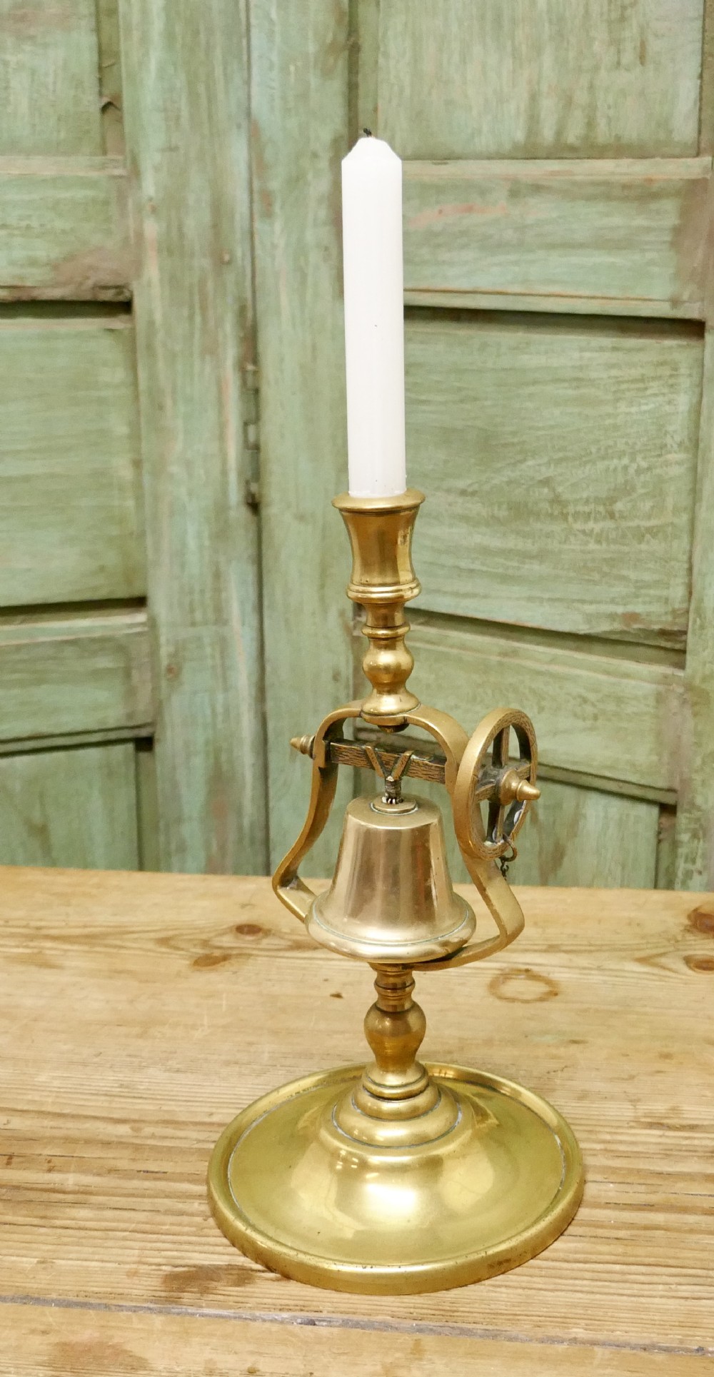 a 19th century brass candle stick with gimbal bell