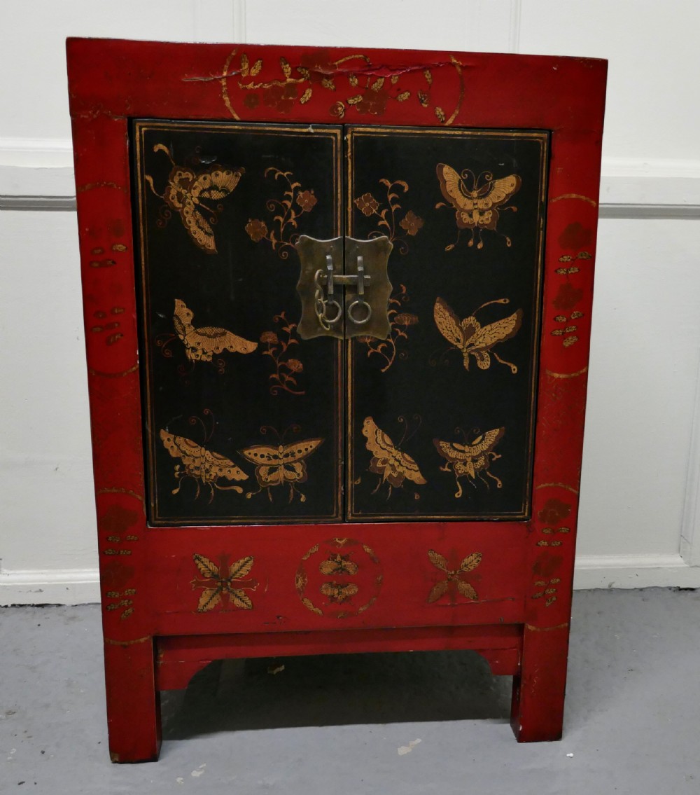 red and black chinoiserie lacquer cupboard decorated with butterflies