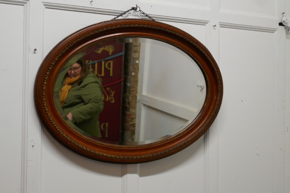 a large edwardian oval wall mirror