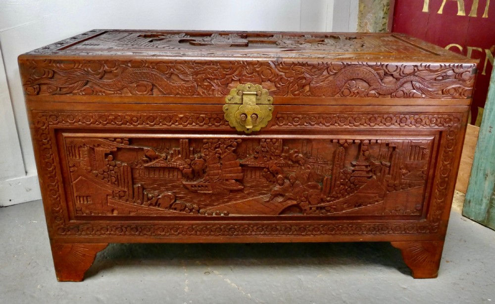 a carved oriental camphor wood chest