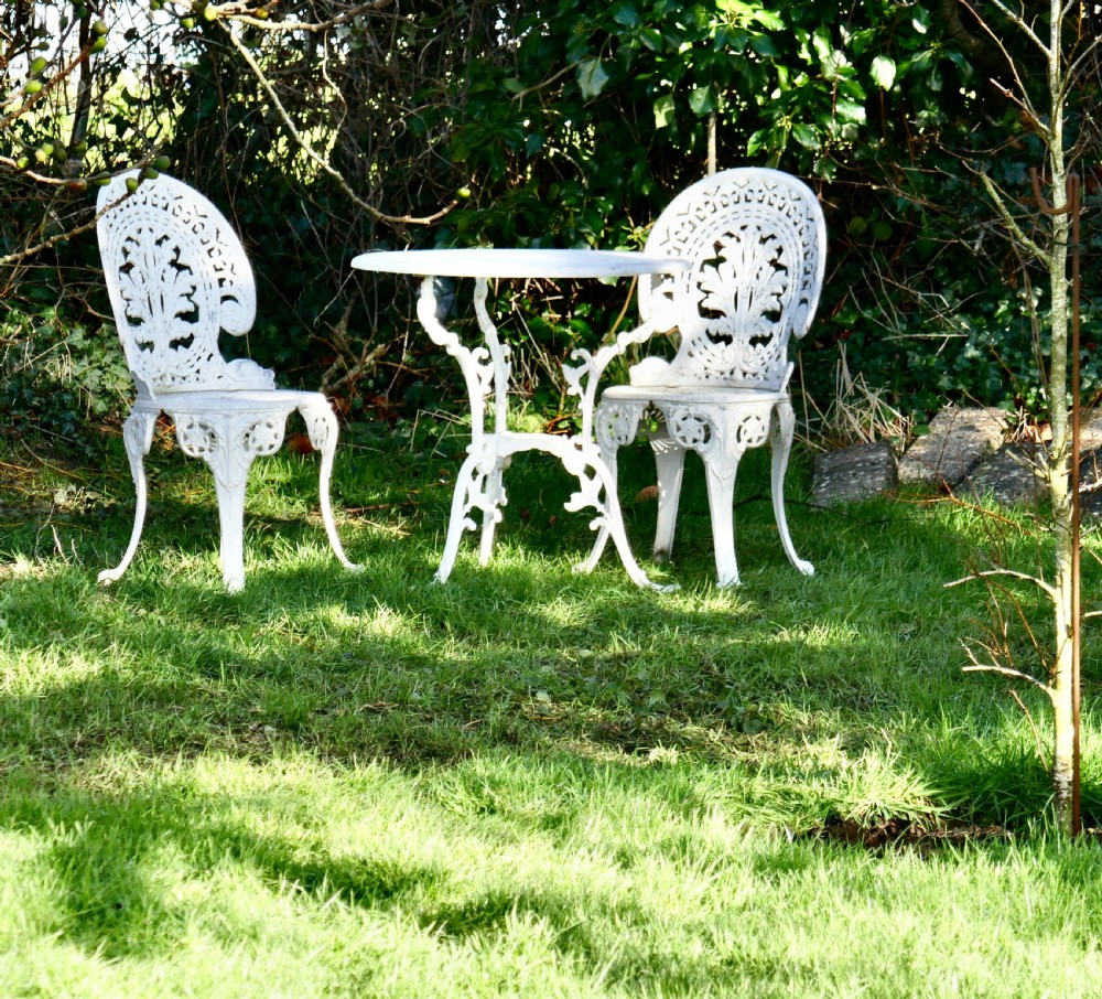 nicely weathered painted metal bistro set table and 2 chairs