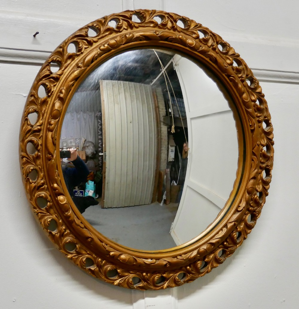 carved convex gilt wall mirror