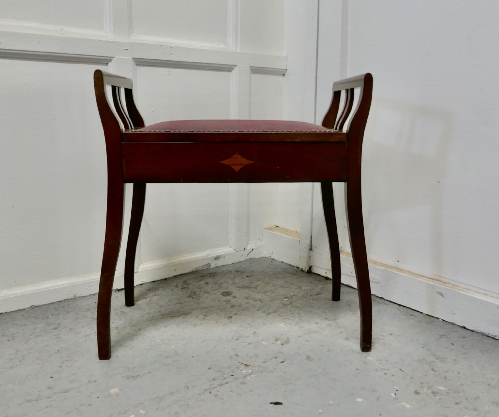 an edwardian inlaid mahogany piano stool