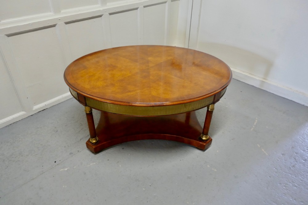 a large regency walnut and brass oval coffee table