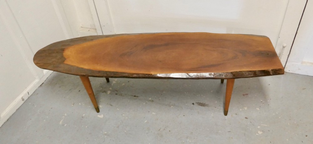 a mid century slice of fruitwood coffee table