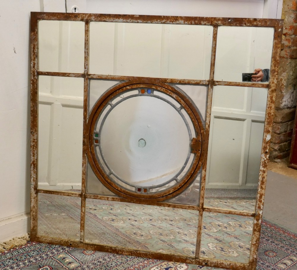 large 19th century industrial window mirror with central leaded bottle glass opening