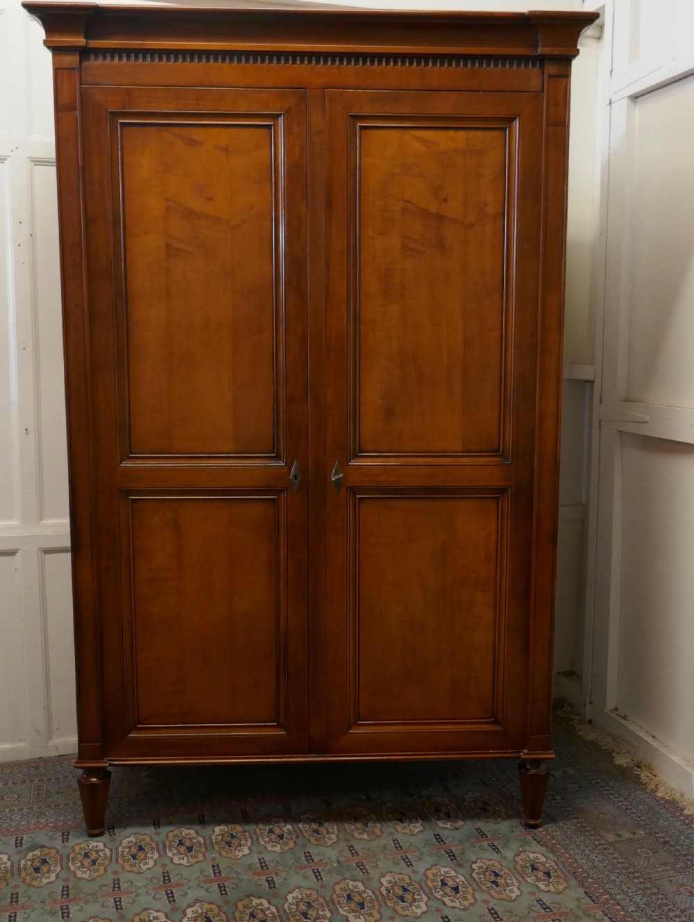 a solid fruitwood shelved armoire hanging wardrobe