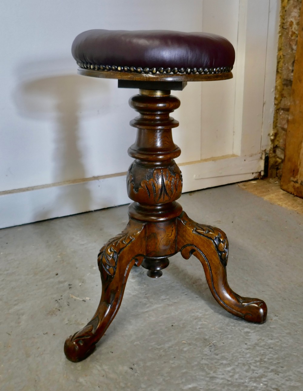 an elegant victorian walnut and leather stool