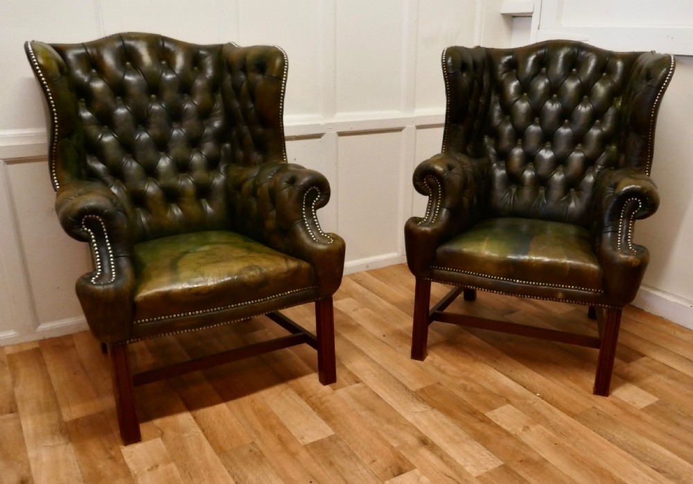 a pair of gentlemans wing back leather chesterfield library chairs
