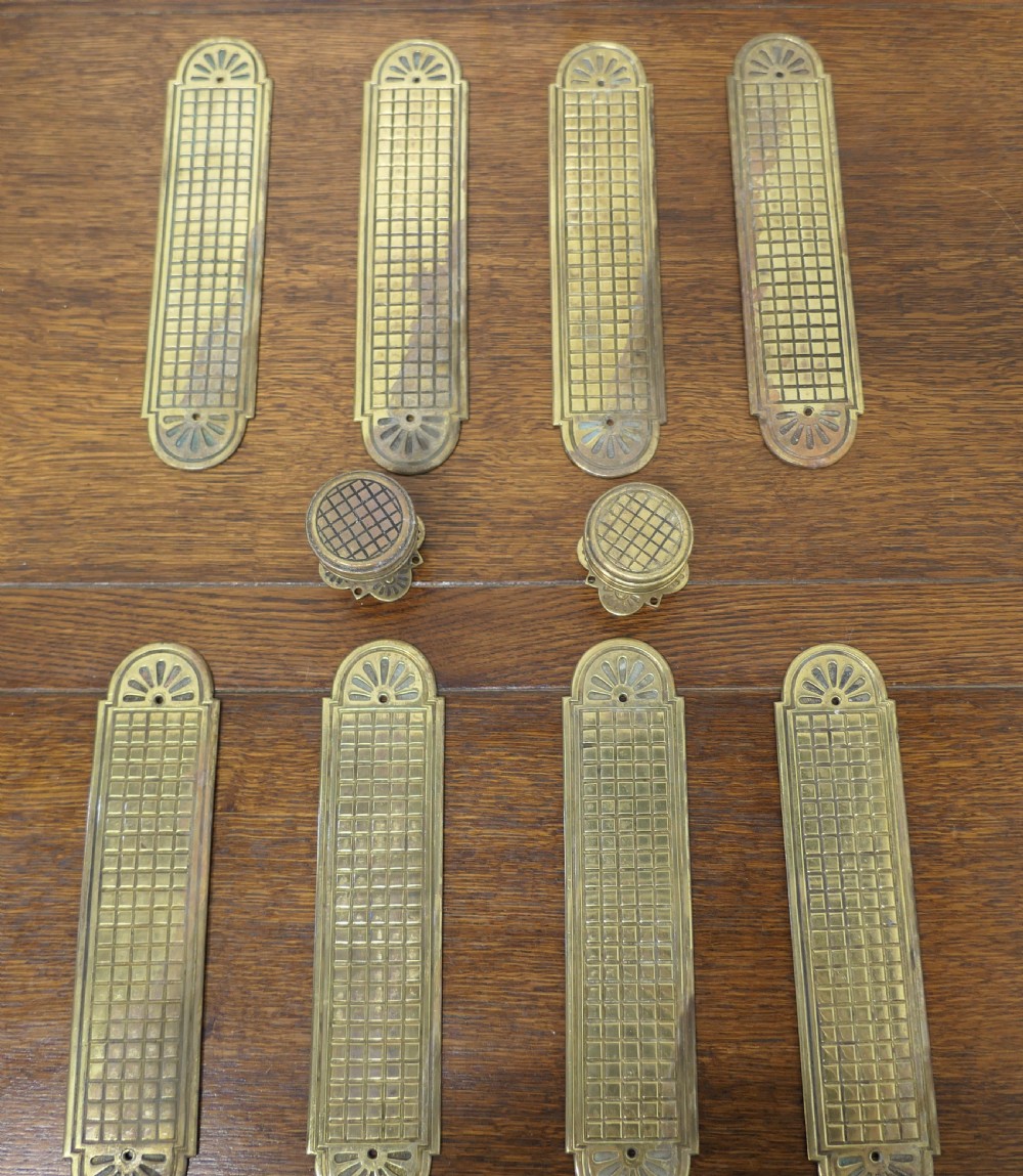 a set of 19th century arts and crafts brass door finger plates and knobs