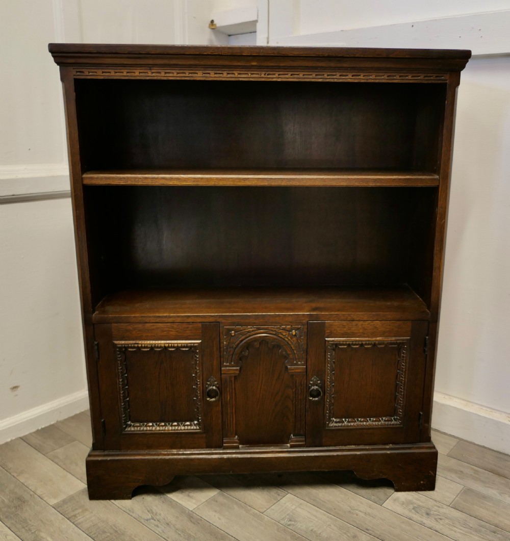 gothic carved oak open bookcase with cupboard by old charm