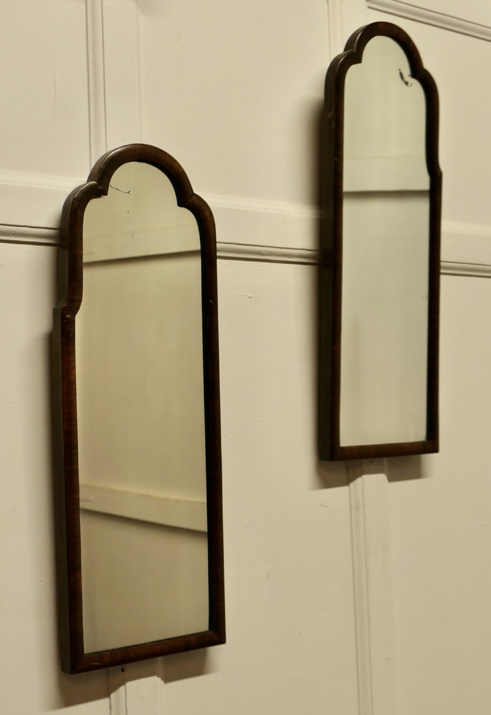 a pair of art deco asymmetric walnut mirrors