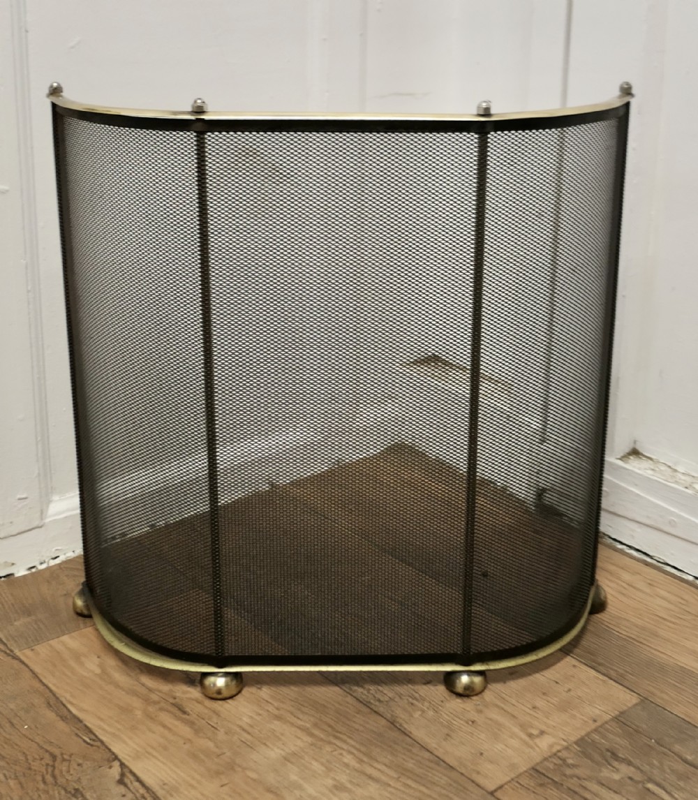 curved brass and iron nursery fire guard