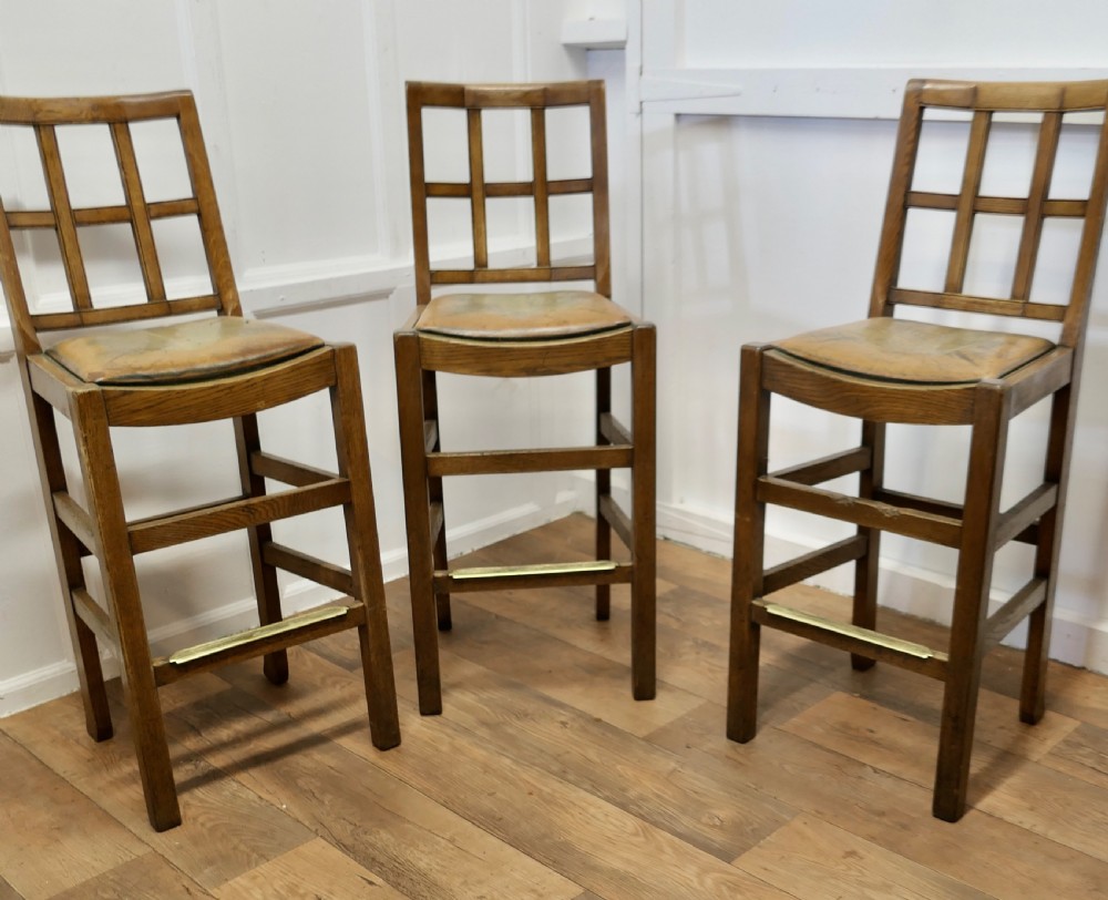 a rare trio of arts and crafts high bar stools in golden oak