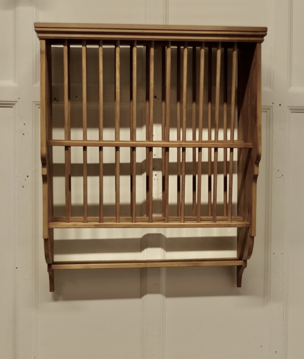 a large wall hanging pine plate rack